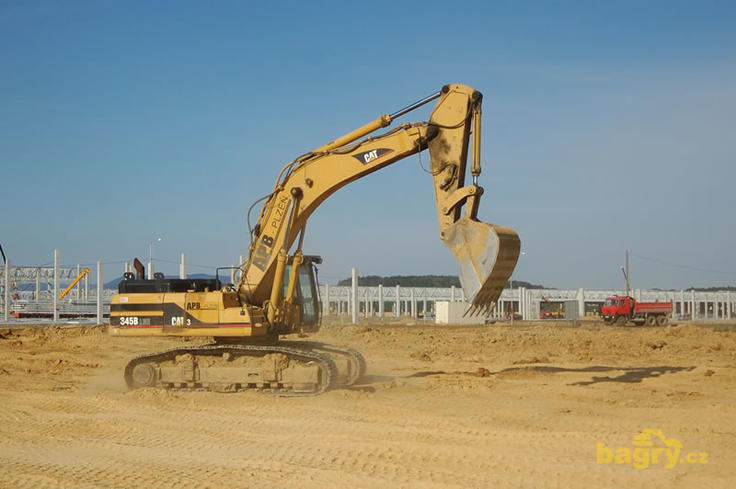 Pásové rypadlo Caterpillar 345B LME se přesouvá na další štaci