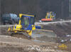 Pásový dozer Komatsu D61 EX, v pozadí smykem řízený nakladač Locust L 903, obojí firmy Doprastav