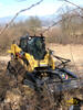 Pásový smykem řízený Caterpillar 277C High Flow XPS s křovinořezem Caterpillar BR172