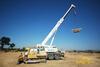 Pásový dozer Liebherr PR 712 Litronic firmy PSJ servis před autojeřábem téže značky firmy H.A.N.S. stavby