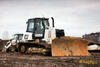 Pásový dozer Caterpillar D6K firmy Hochtief složený z podvalníku