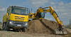 13. Kolové rypadlo JCB JS 175W při nakládání zeminy na Tatru 8x8 Phoenix Euro 6 sklápěč