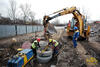 Rypadlonakladač Caterpillar 428D firmy Walco osazuje betonovou šachtovou skruž