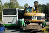 Kolové rypadlo Caterpillar M313C objížděné autobusem Iveco Irisbus