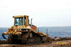 Dozer Caterpillar D6N XL firmy Sedos stavby v pozadí s lomem ČSA