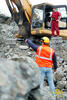 Strojník pásového rypadla Komatsu PC350LC-8 poslouchá pokyny vedoucího lomu pana Remuty