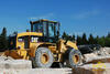 Kolový nakladač Caterpillar 928G Z s roštovou lopatou EBF Heavy Duty s přidržovačem