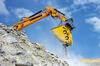 Drticí lžíce Atlas Copco BC 2500 na pásovém rypadle Liebherr R922 Litronic