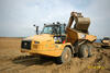 Kloubový dempr Caterpillar 730C2 nakládaný rypadlem Caterpillar 325C LNME