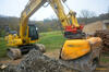 19. Pásové rypadlo Komatsu PC240NLC-11 z půjčovny DEK s drticí lžící Hartl Crusher HBC 650